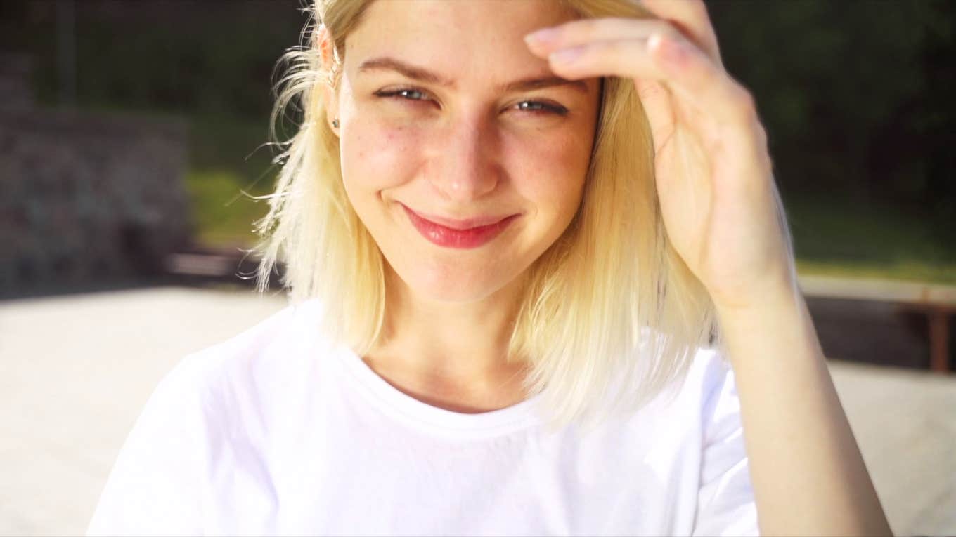 Woman smiling slightly coy showing why certain affirmations are shockingly effective even for skeptics