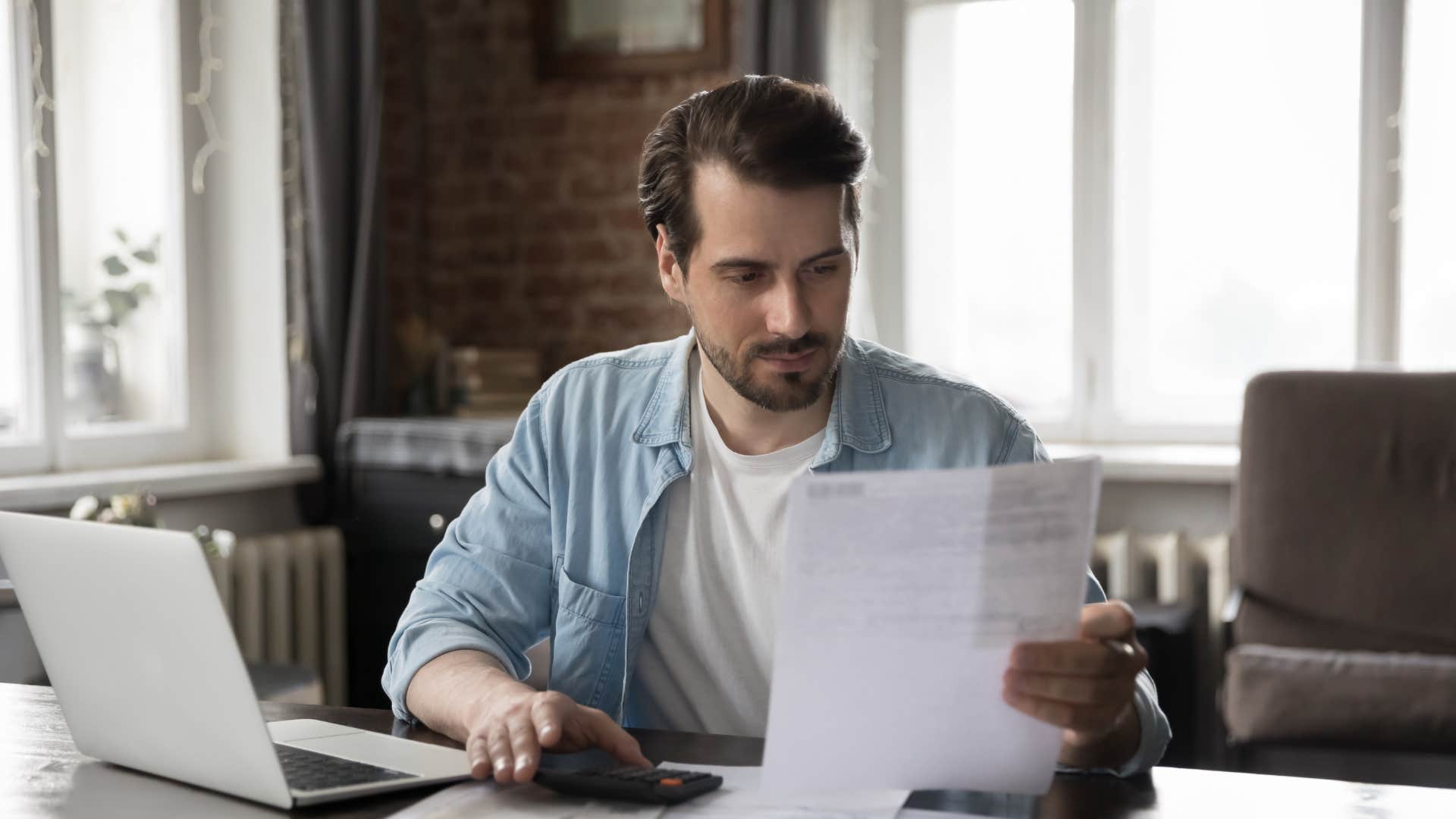 man looking at bill unable to afford emergency costs