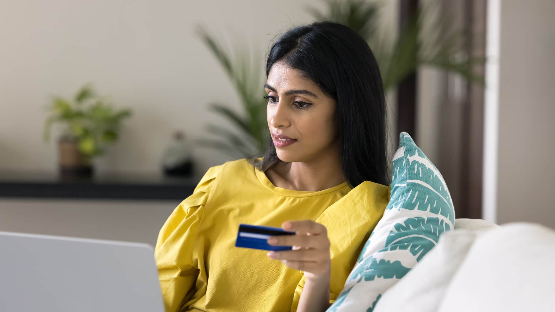 woman looking at bill after paycheck disappears within days