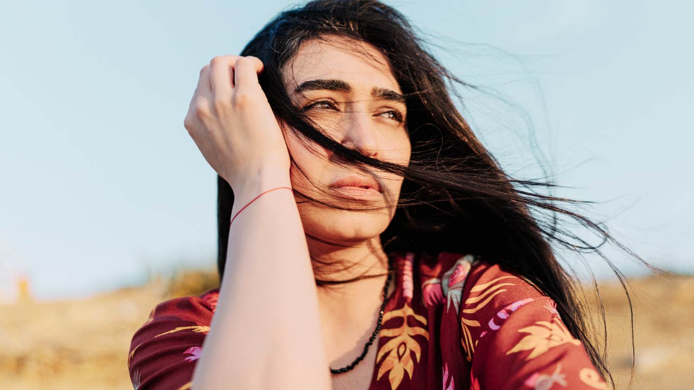 Serene person sitting quietly in reflection, symbolizing spiritual growth and the moment you realize you’ve passed your soul’s most painful test.