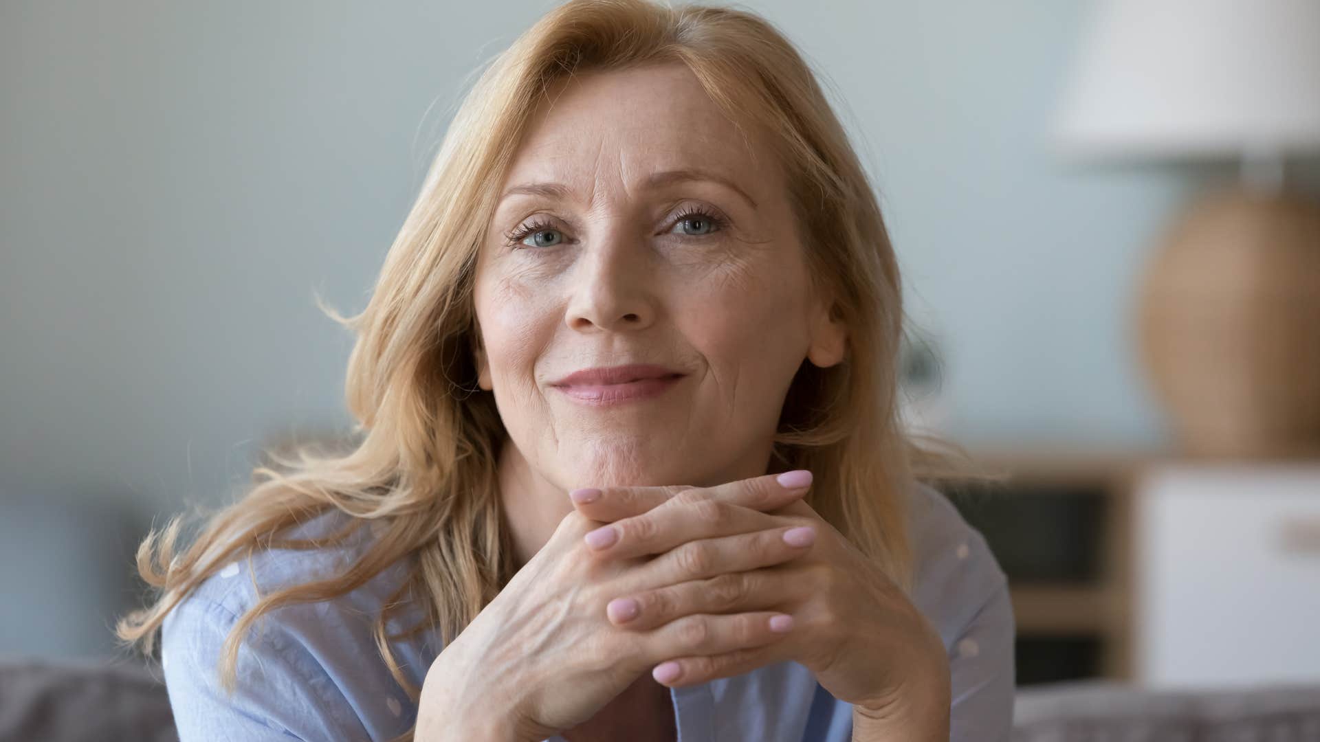 intuitive woman with good energy smiling at home