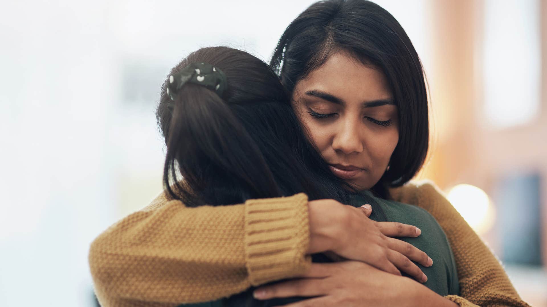 woman who stands up for people hugging a friend