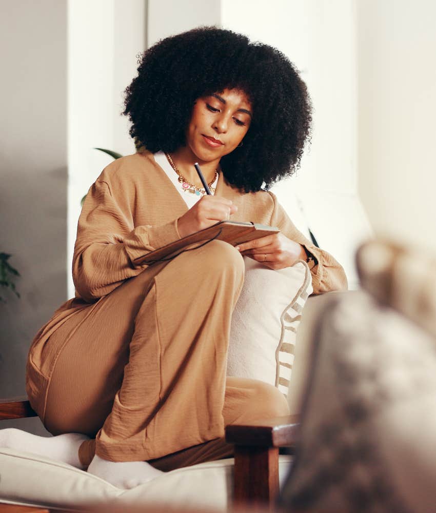 Person stays present reflecting and writing in journal
