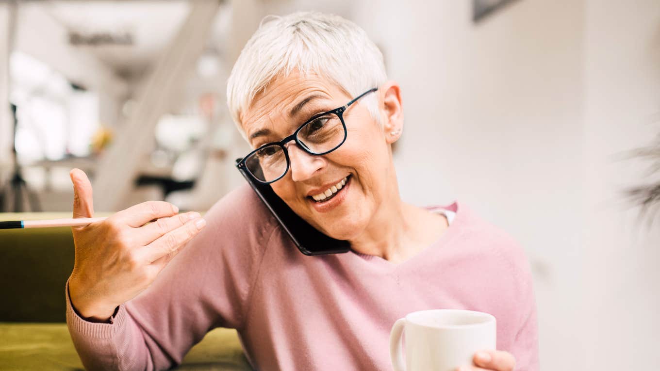 Warm parent happily talking on the phone with an adult child showing the simple habits of parents whose grown kids actually want to call them.