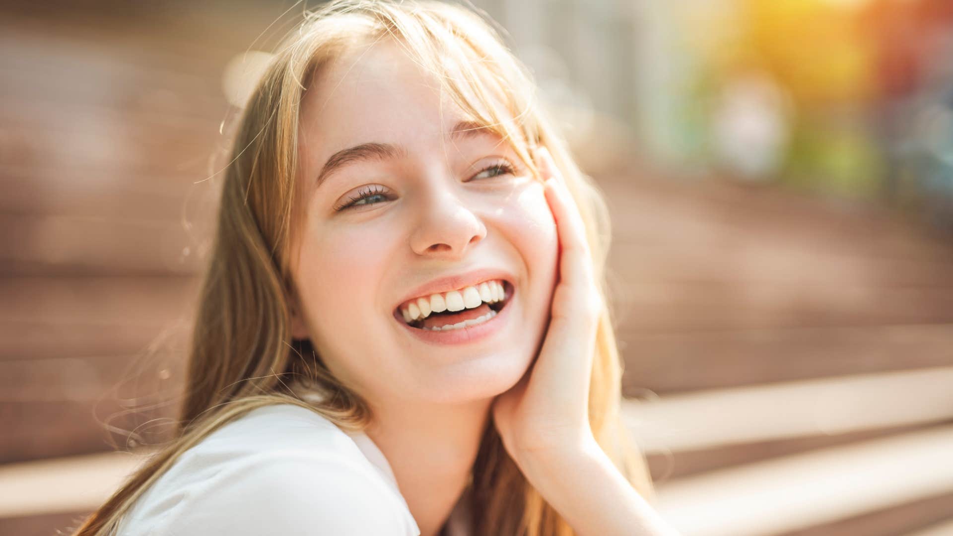 woman who is genuinely satisfied with her life as she remembers who is most influential to her happiness