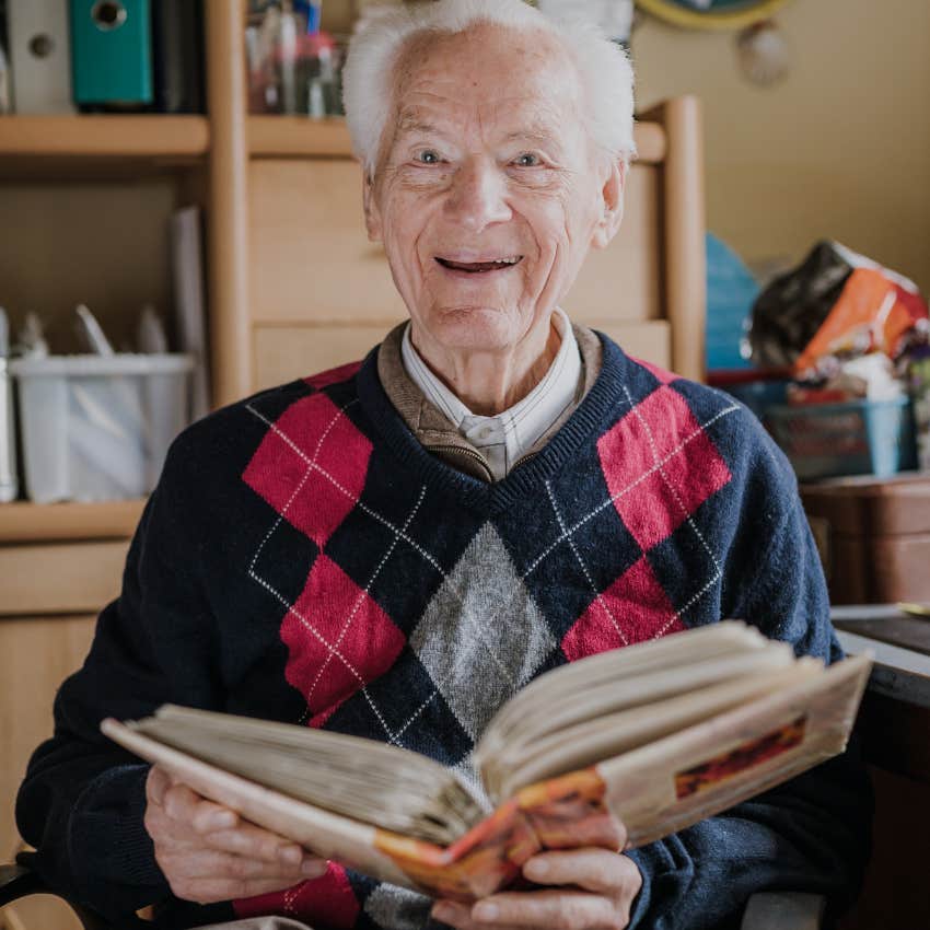 Man looking at photos to unlock childhood memories
