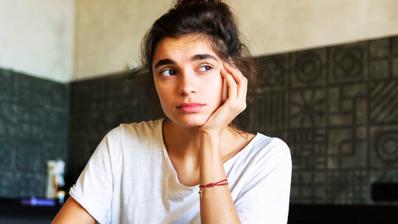 Thoughtful individual at a dining table, considering boundaries and the expert advice that refusing an apology doesn’t make you a bad person.