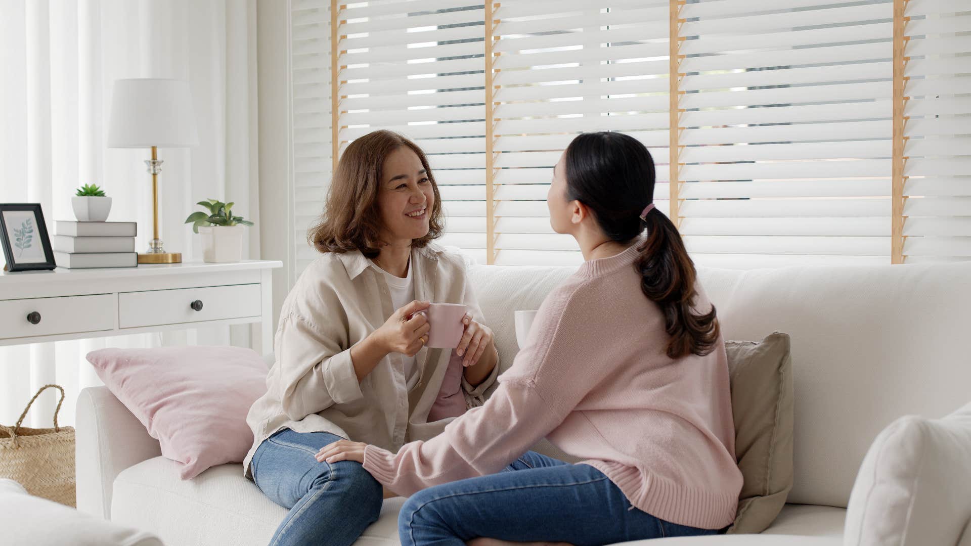 woman talking to each other sitting on the couch
