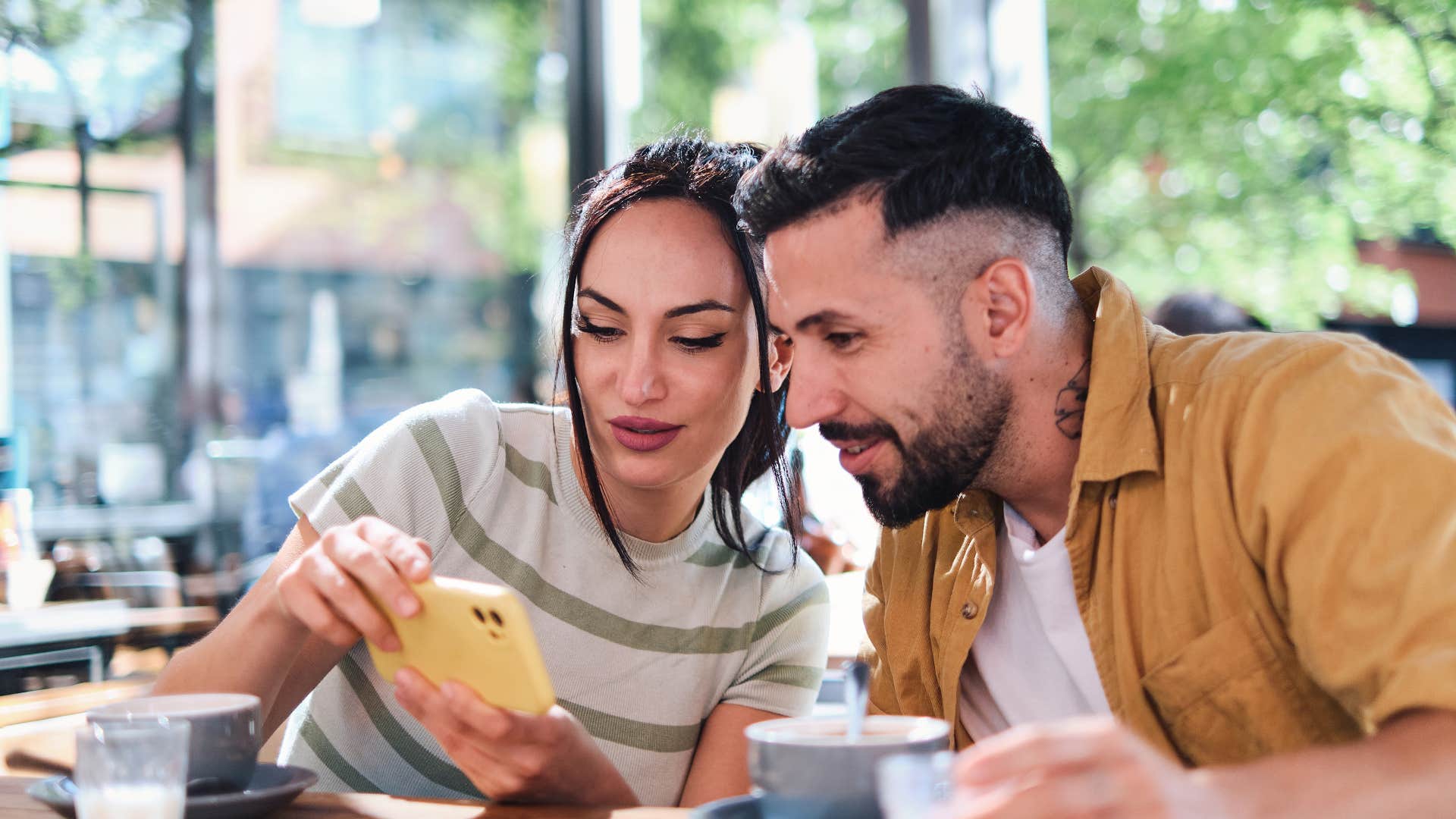 woman showing friend something on her phone