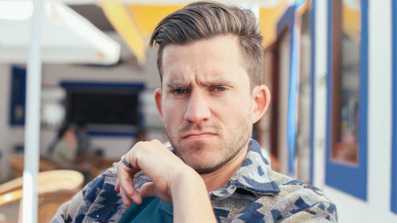 man looking unfriendly sitting outside