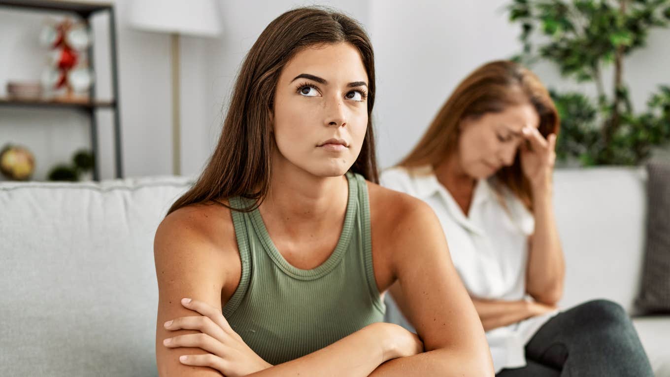 young woman getting defensive to criticism from mom