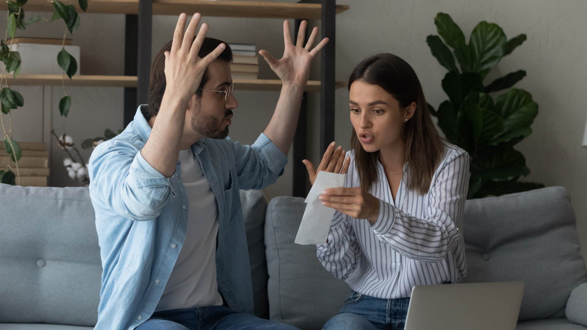 man having a dispute with family member as they argue over bill