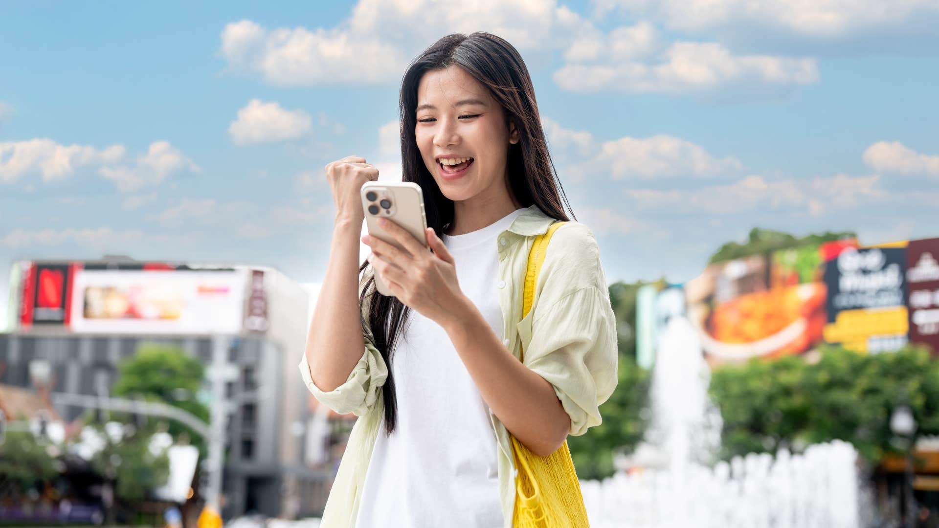 woman in white shirt getting a reimbursement as she checks phone