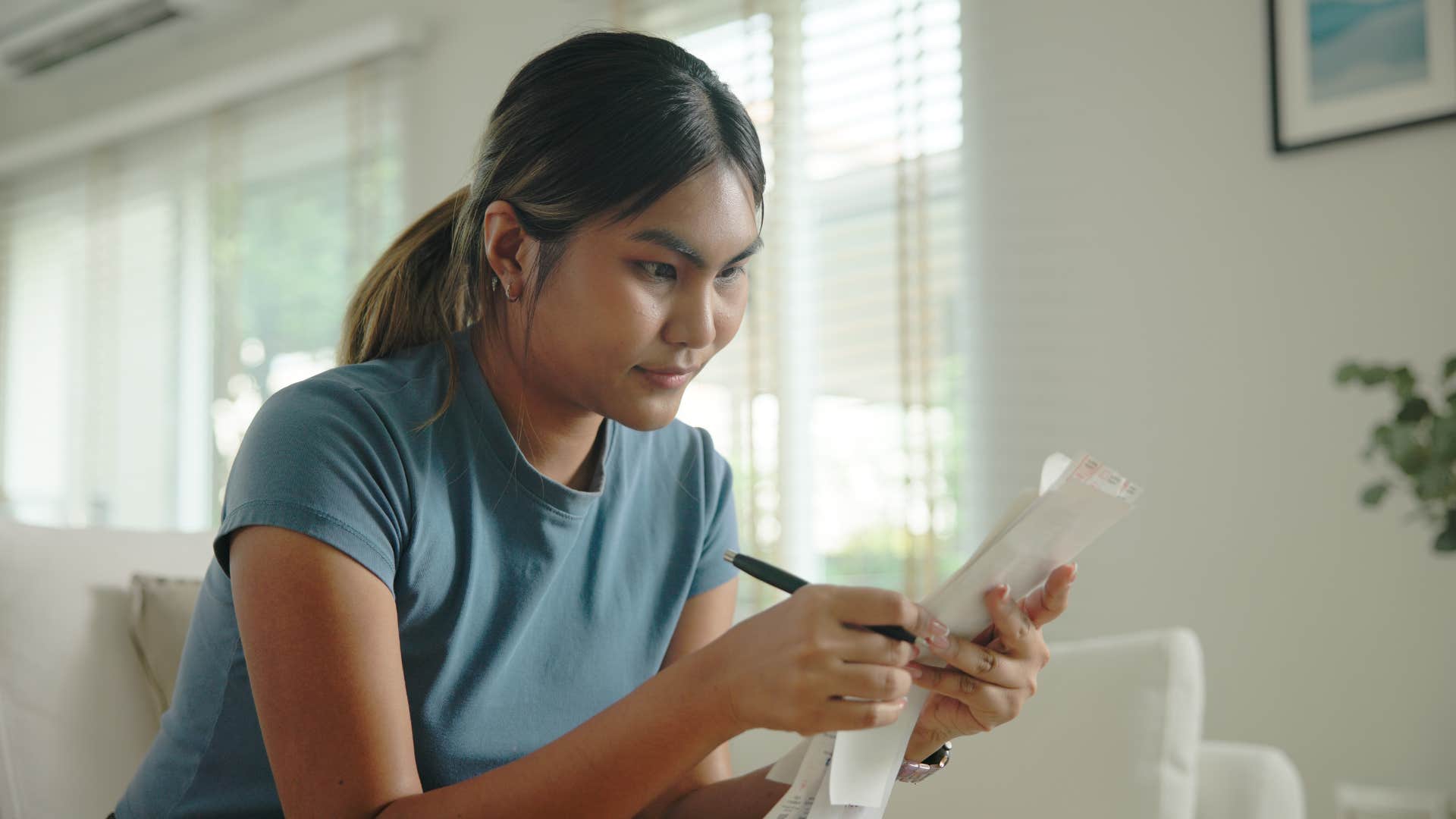 woman in gray shirt checking to see if they're on budget