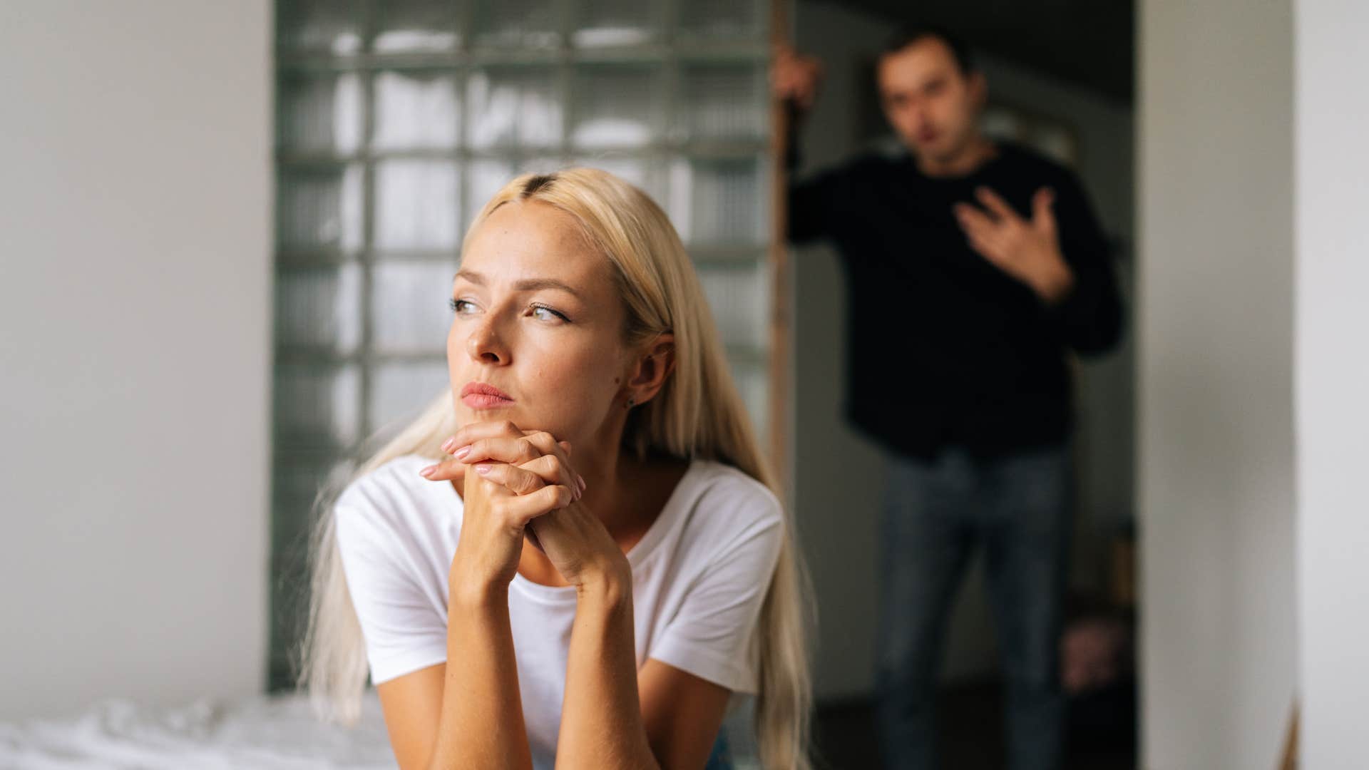 unhappy woman ignoring arguing husband
