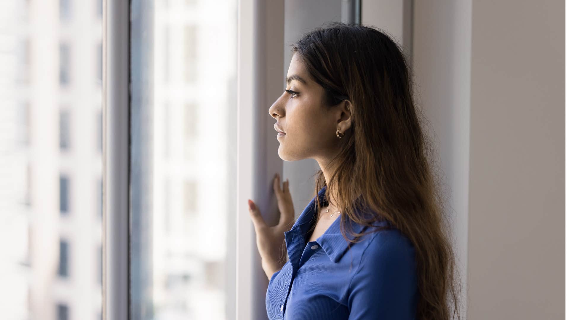 woman who feels empty inside looking out window