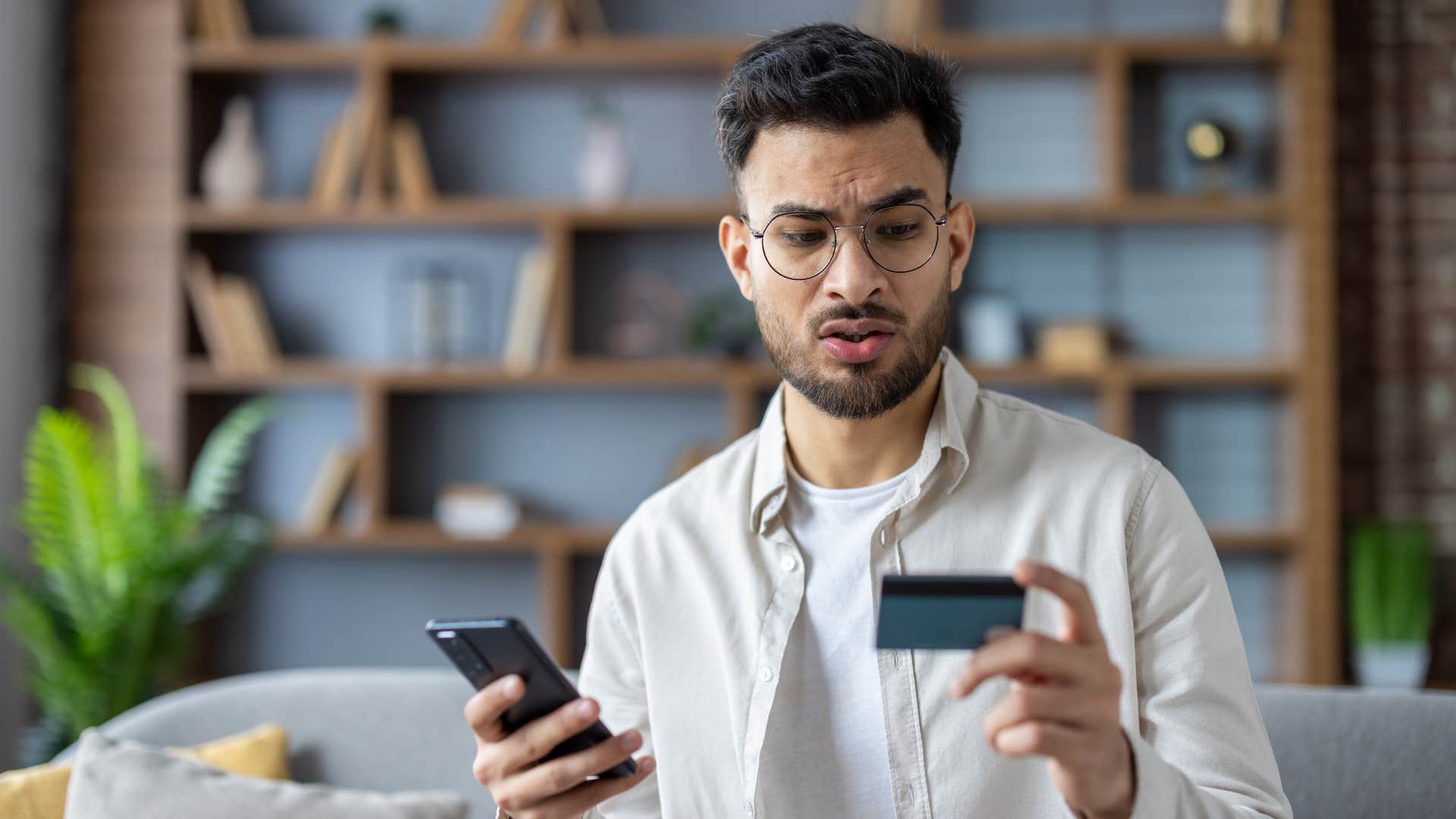 annoyed man buying something with credit card