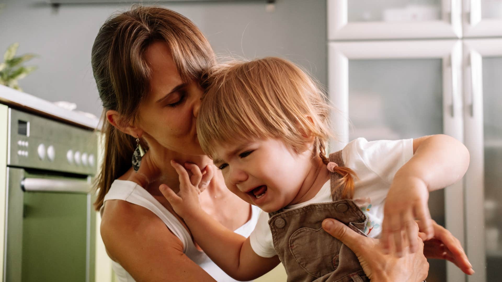 stressed mom raising screaming child