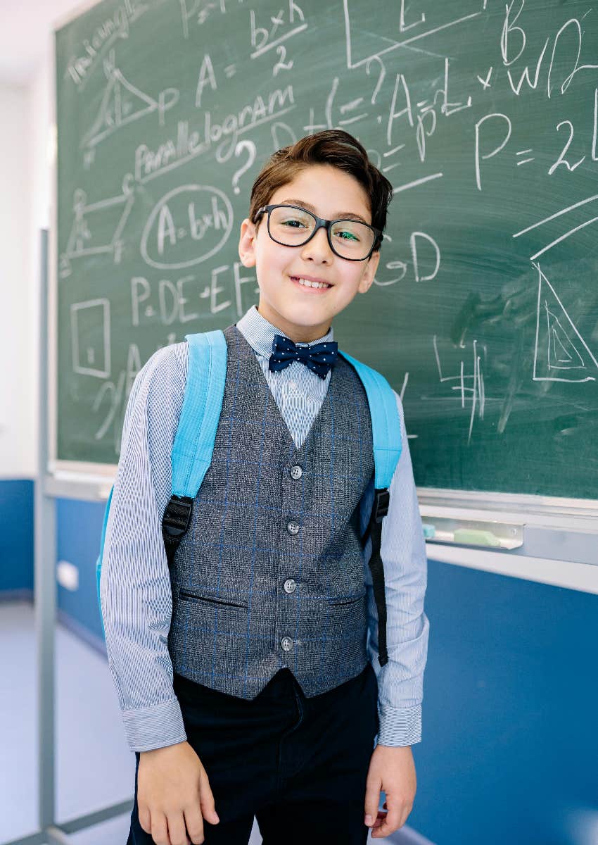 little boy doing math on a chalkboard