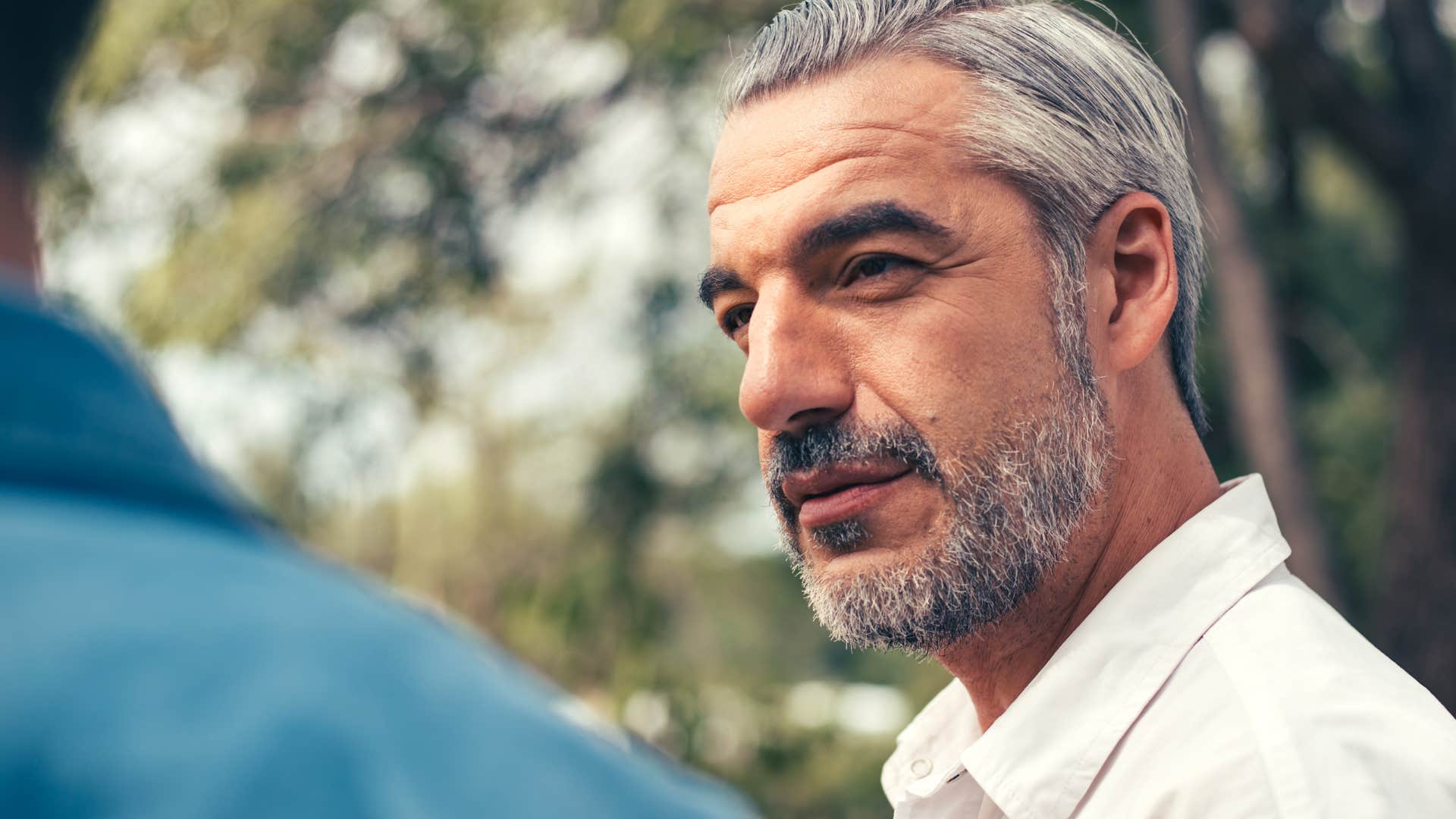 Man who cares less about what other people think talking outside.