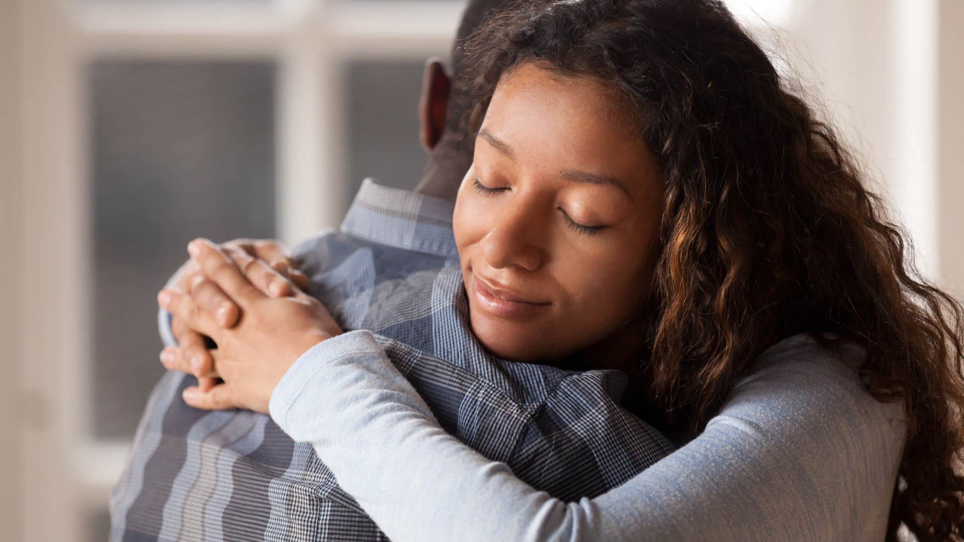 Woman who's kind, but never to a fault, hugging her partner.