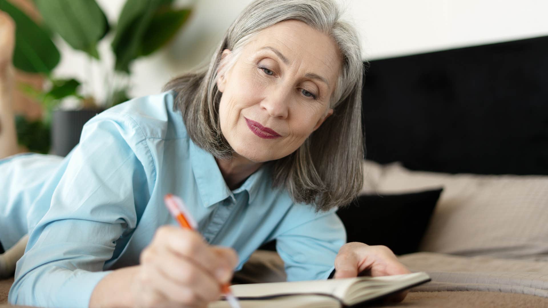 Woman who knows how to take care of themselves writing at home.