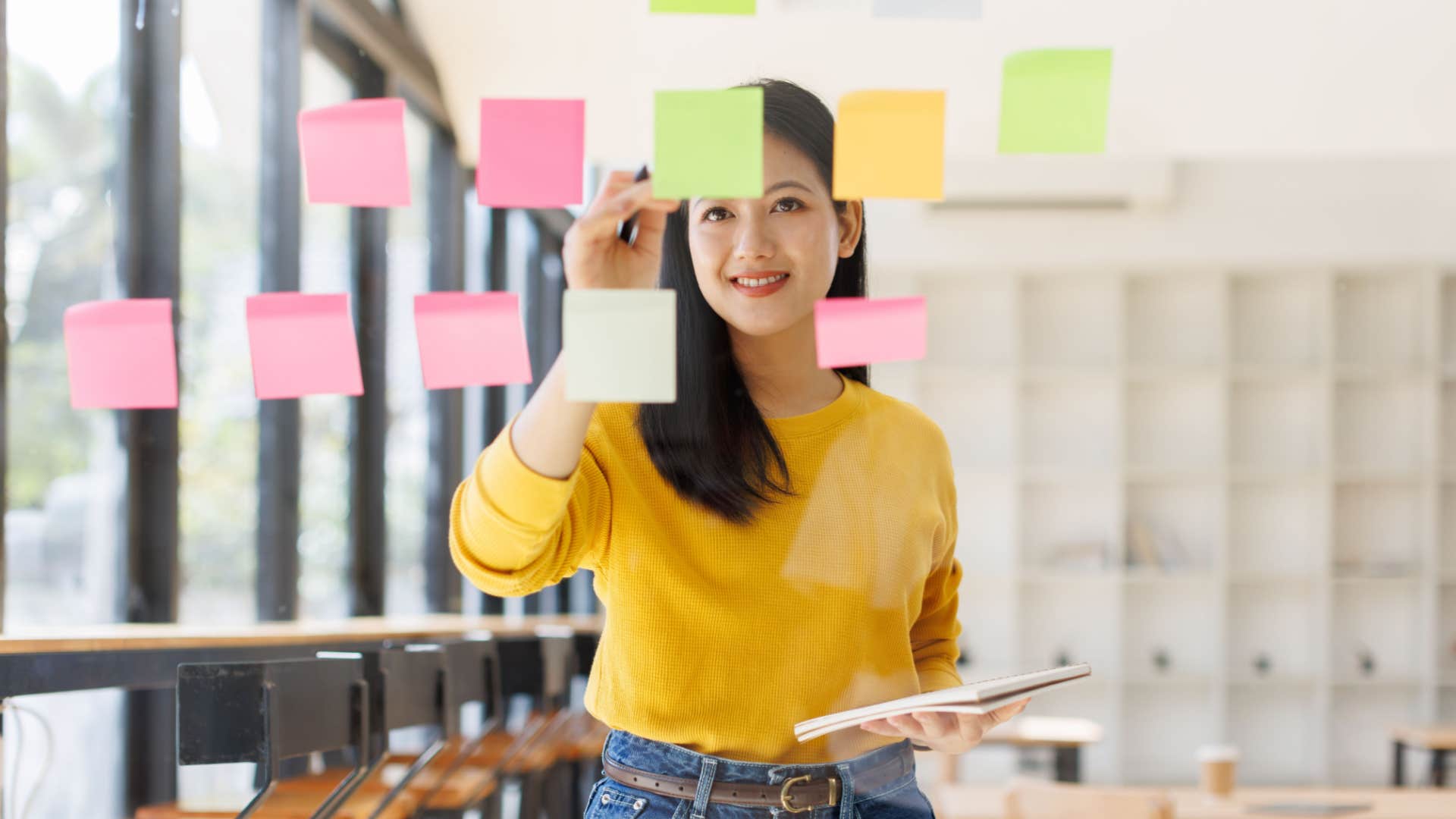 creative woman leaving notes on the wall