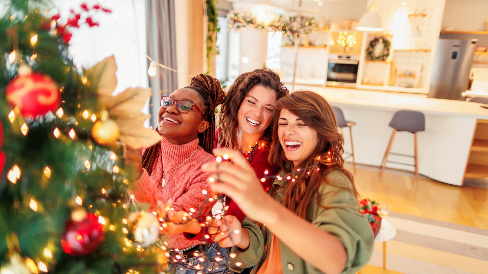 group of friends decorating christmas tree
