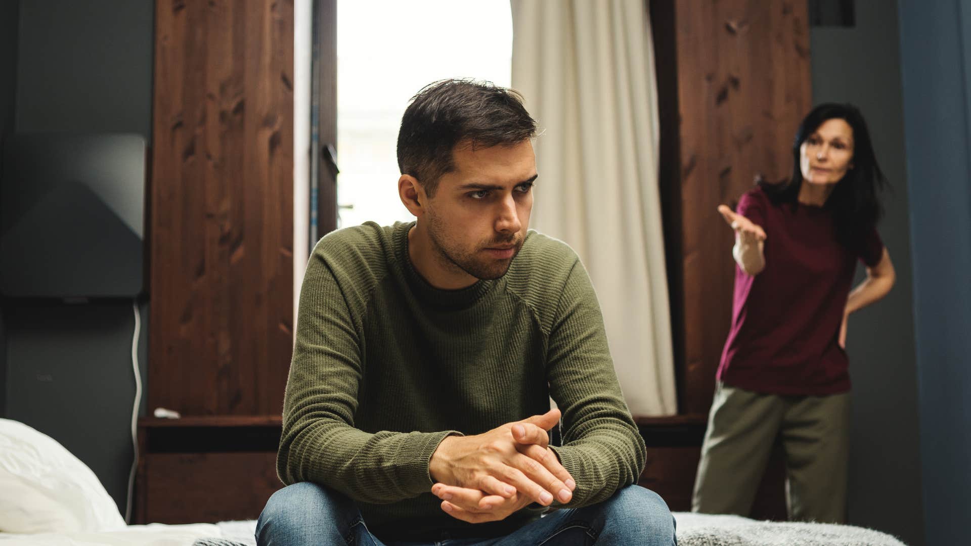 man intentionally ignoring woman trying to talk to him
