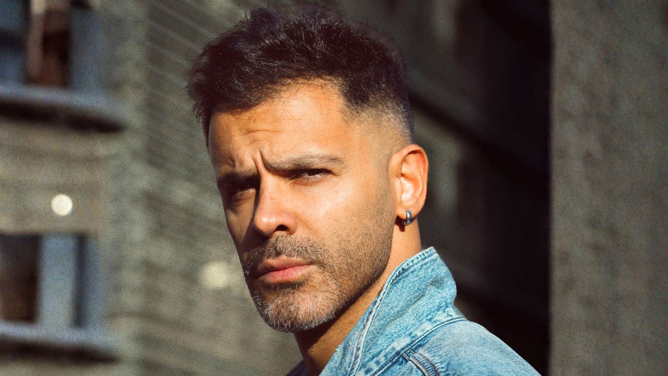 Confident man looking over his shoulder, embodying the firm standards and boundaries of men with true integrity.