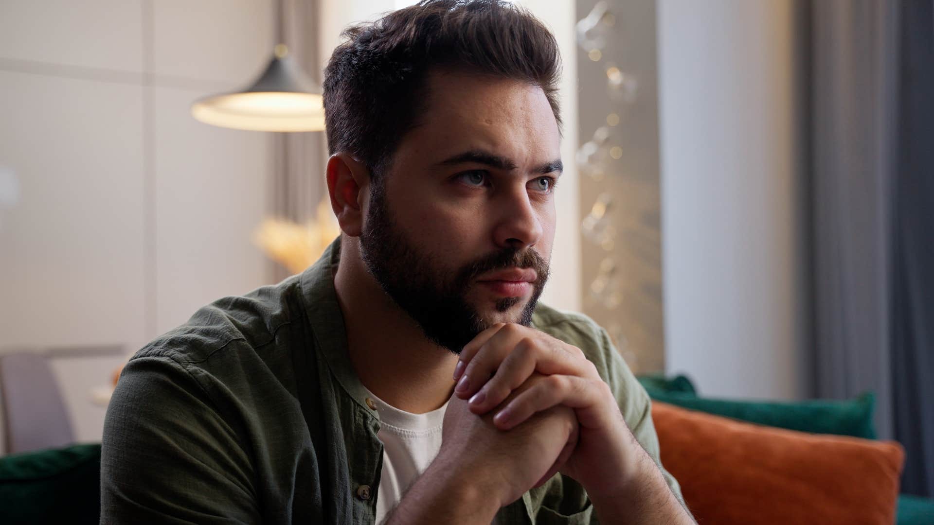 unhappy man procrastinating putting off important tasks