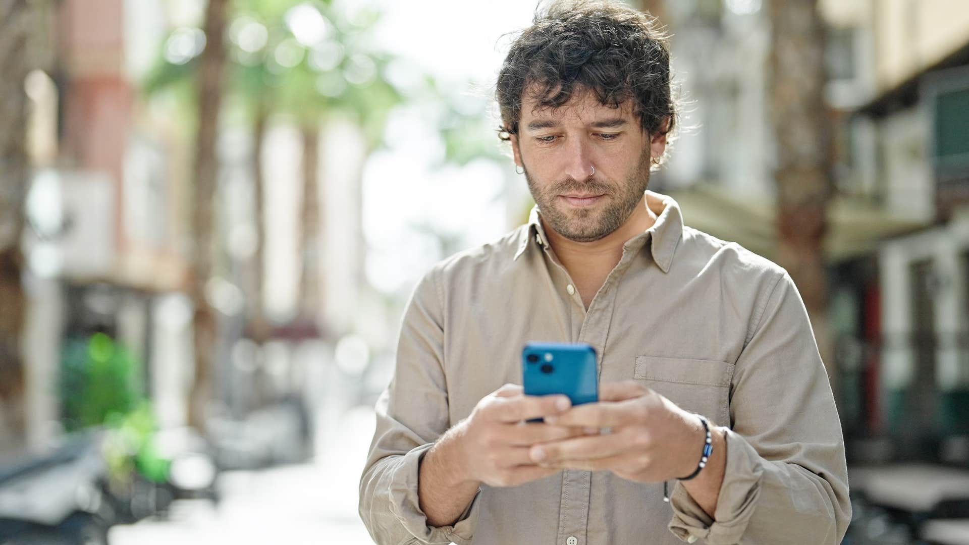 Man looking to see who's liked or seen their content on his phone.