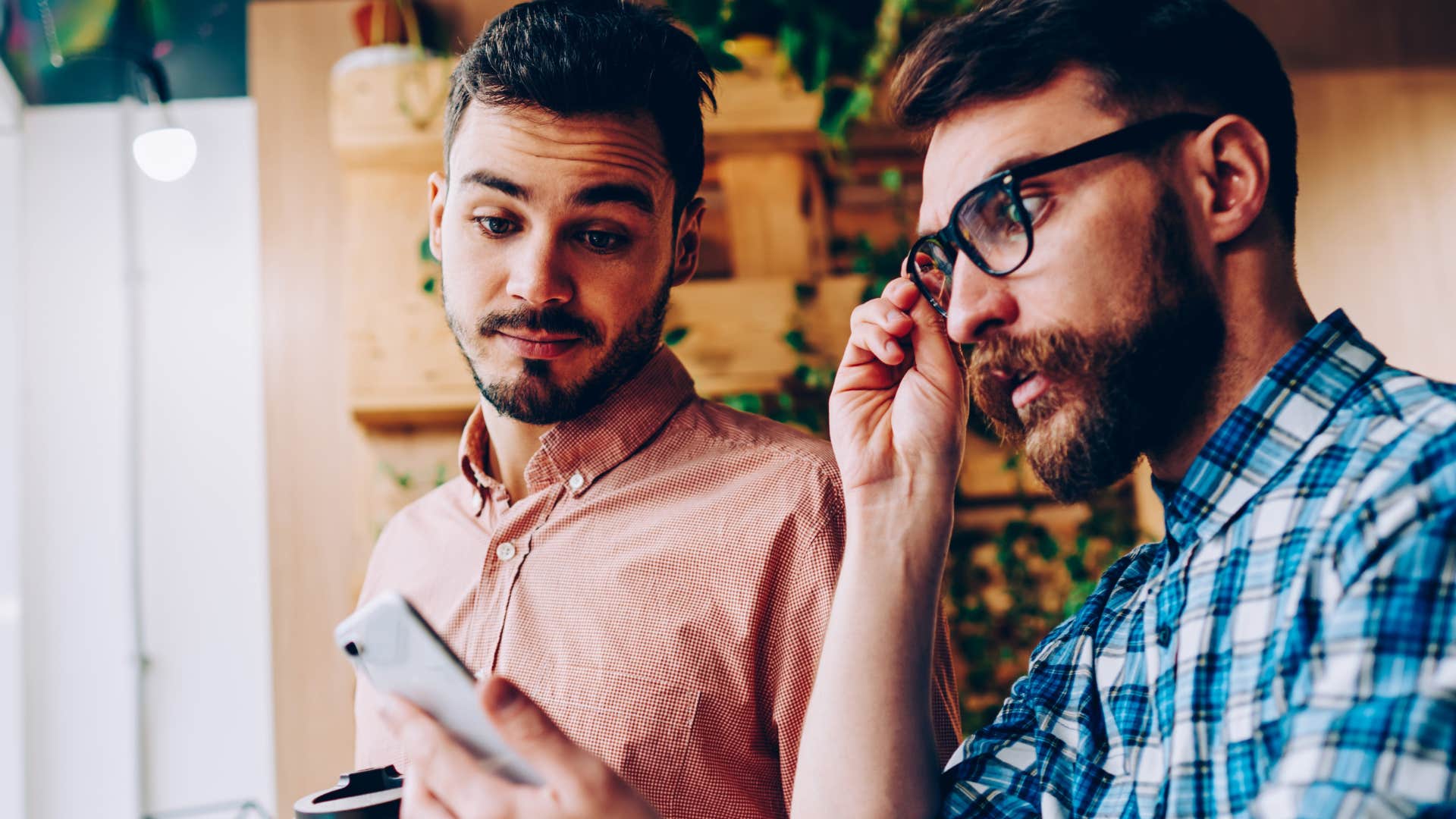 Man multitasking at home on his phone.