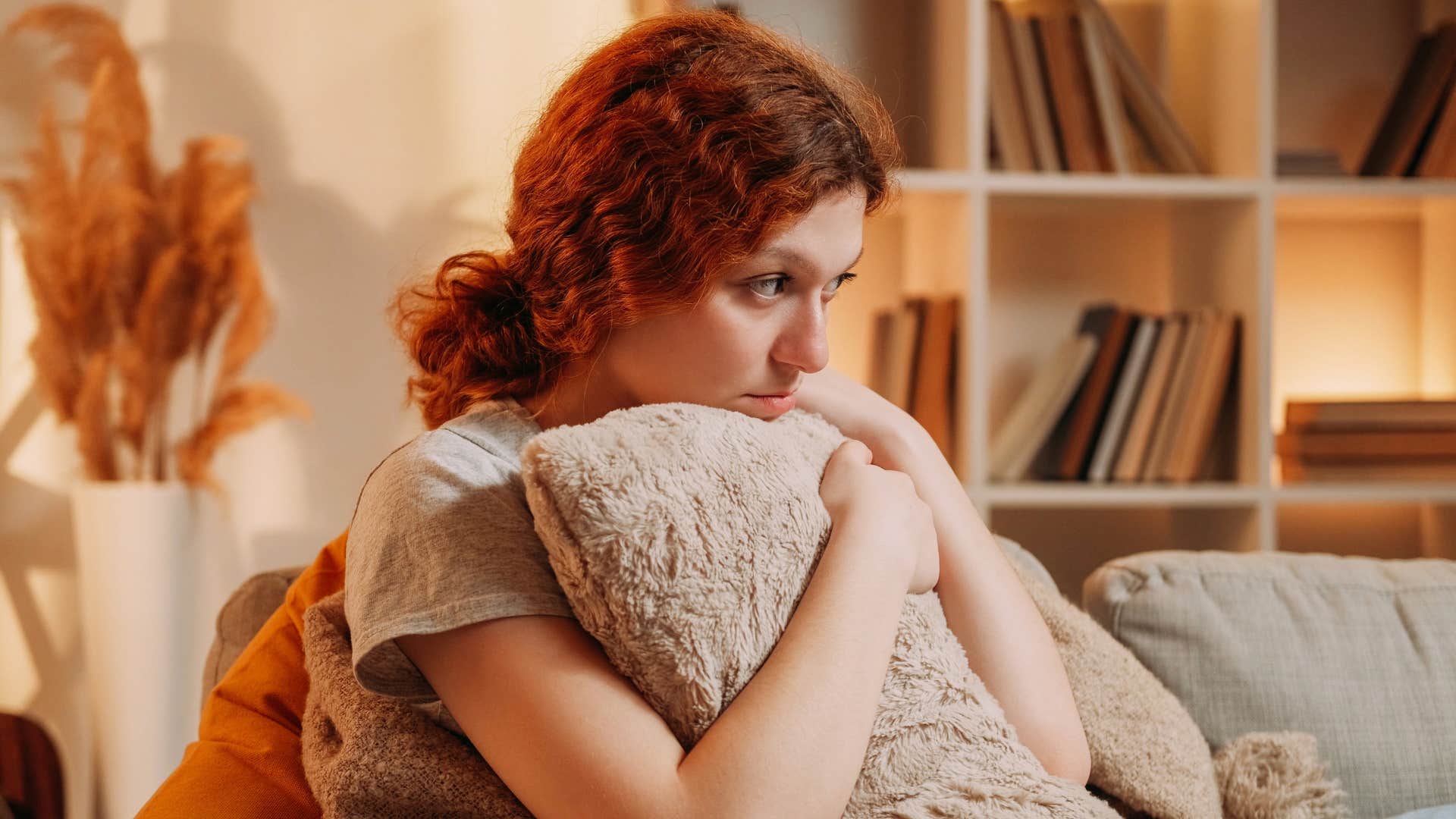 woman clutching pillow overthinking