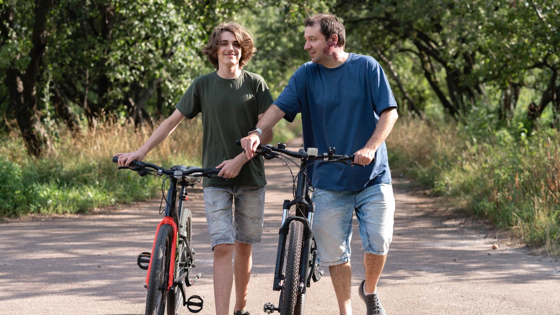 father and son riding bikes together