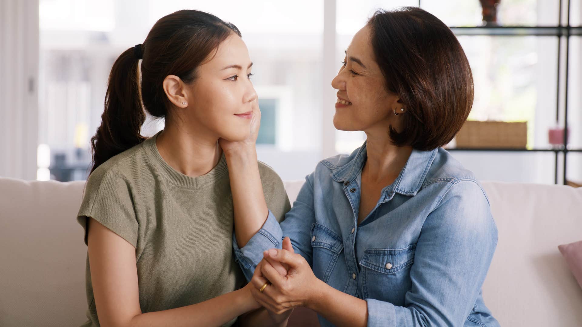 mother and daughter smiling at one another