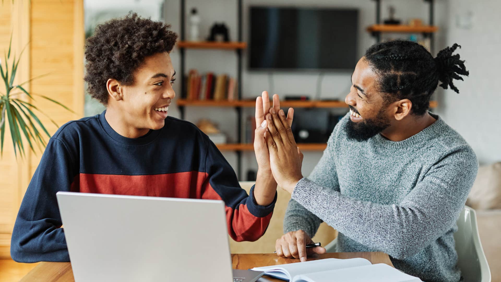 father and son high-fiving