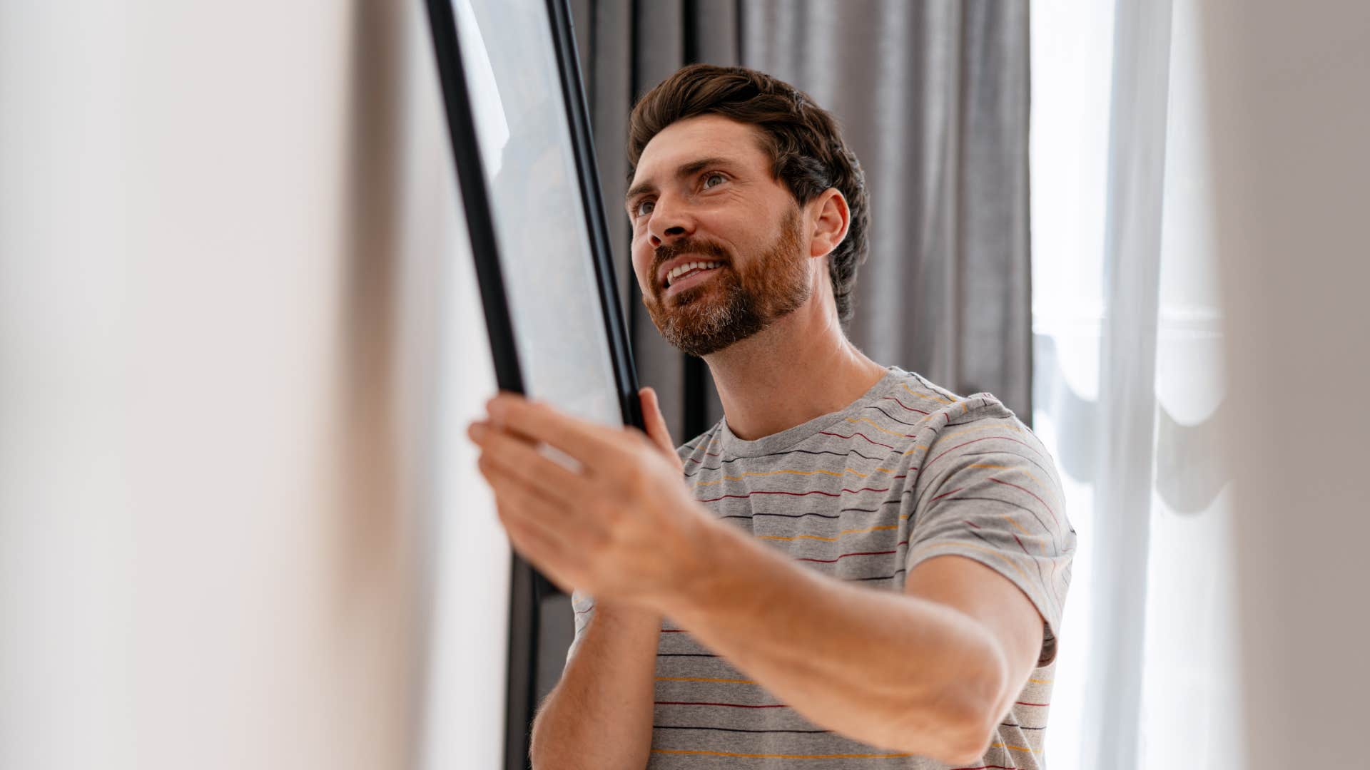 man hanging up wall decor