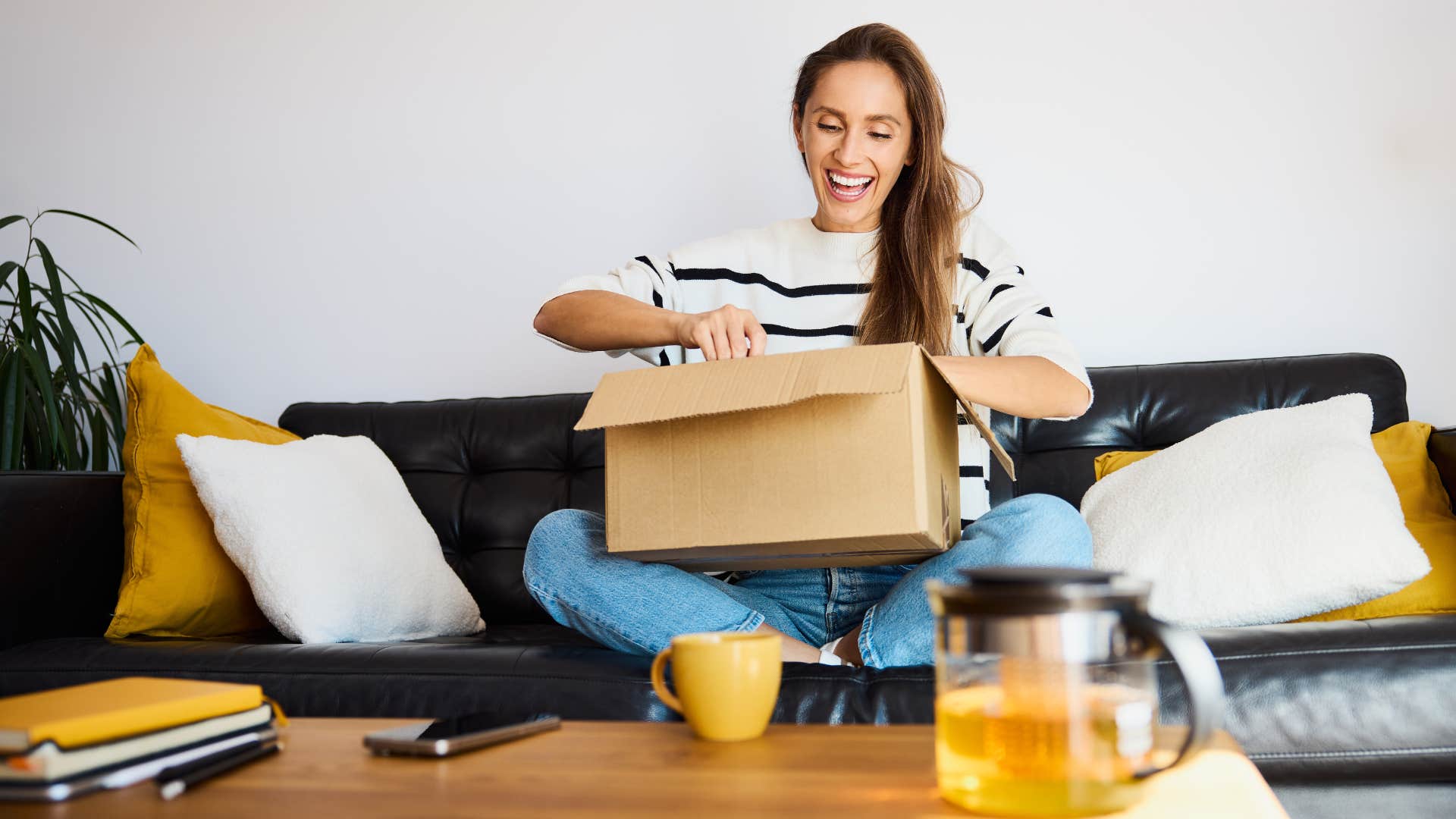 woman opening box in her living room