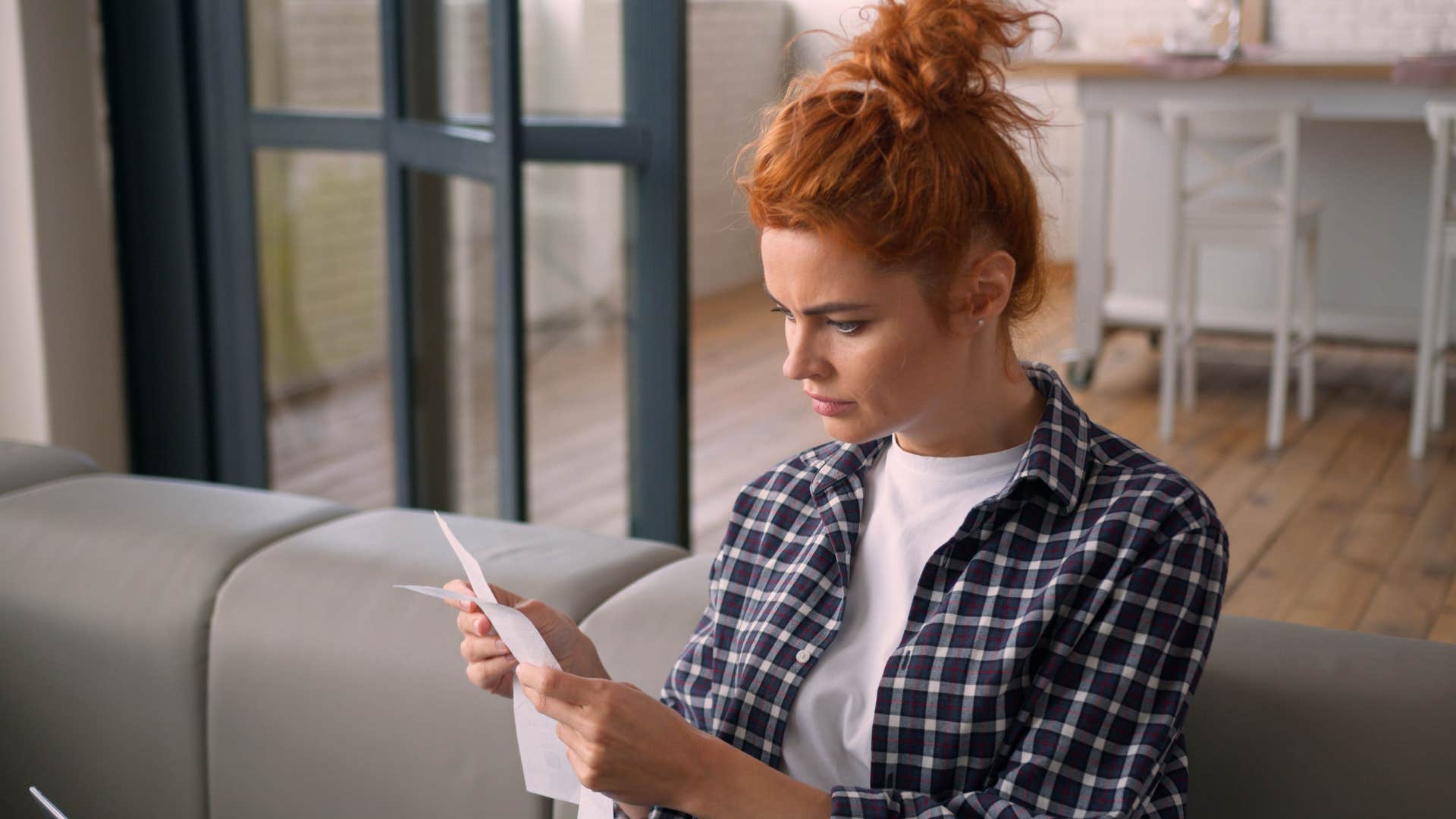 woman looking at receipt