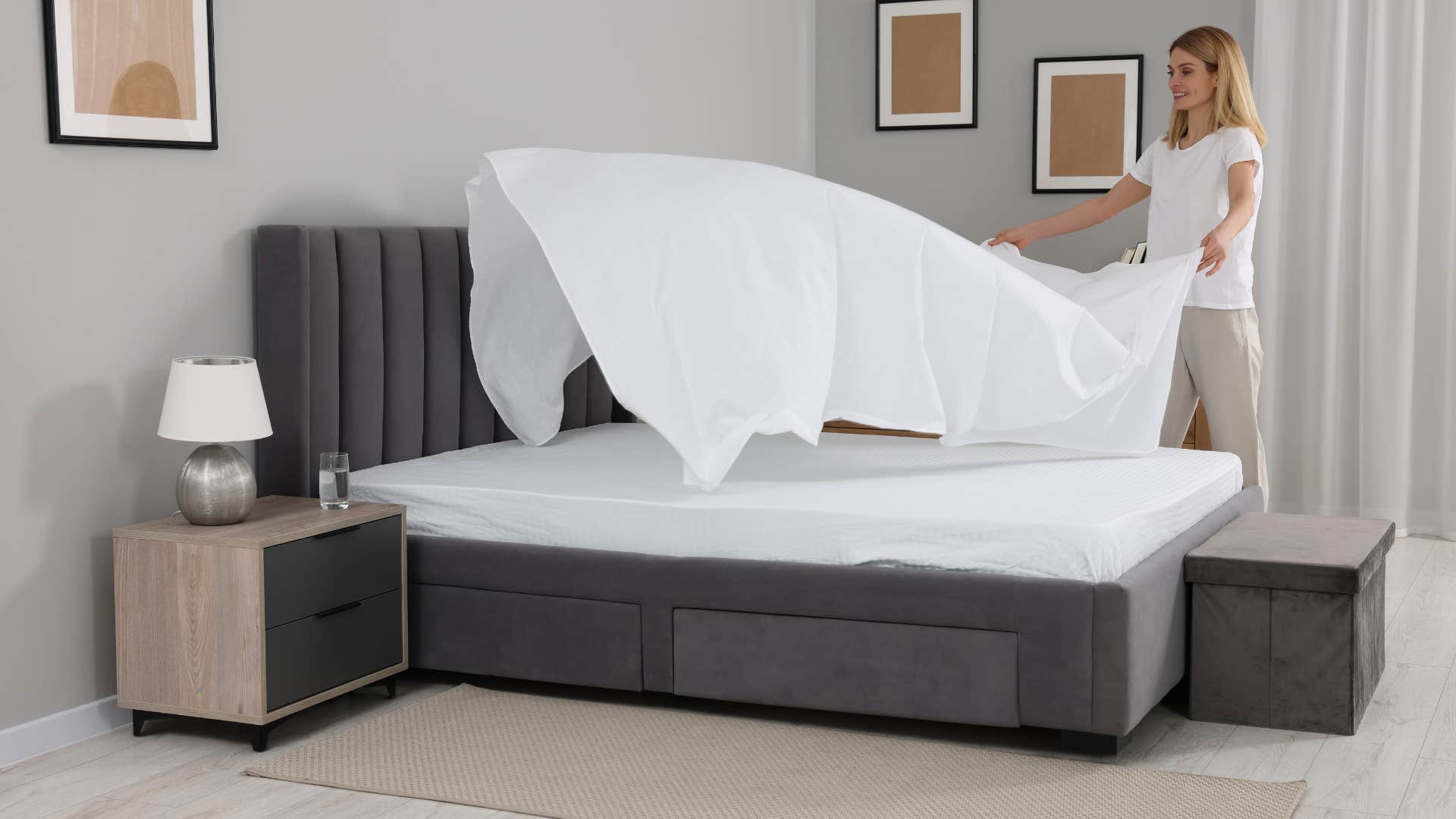 woman changing sheets on her bed