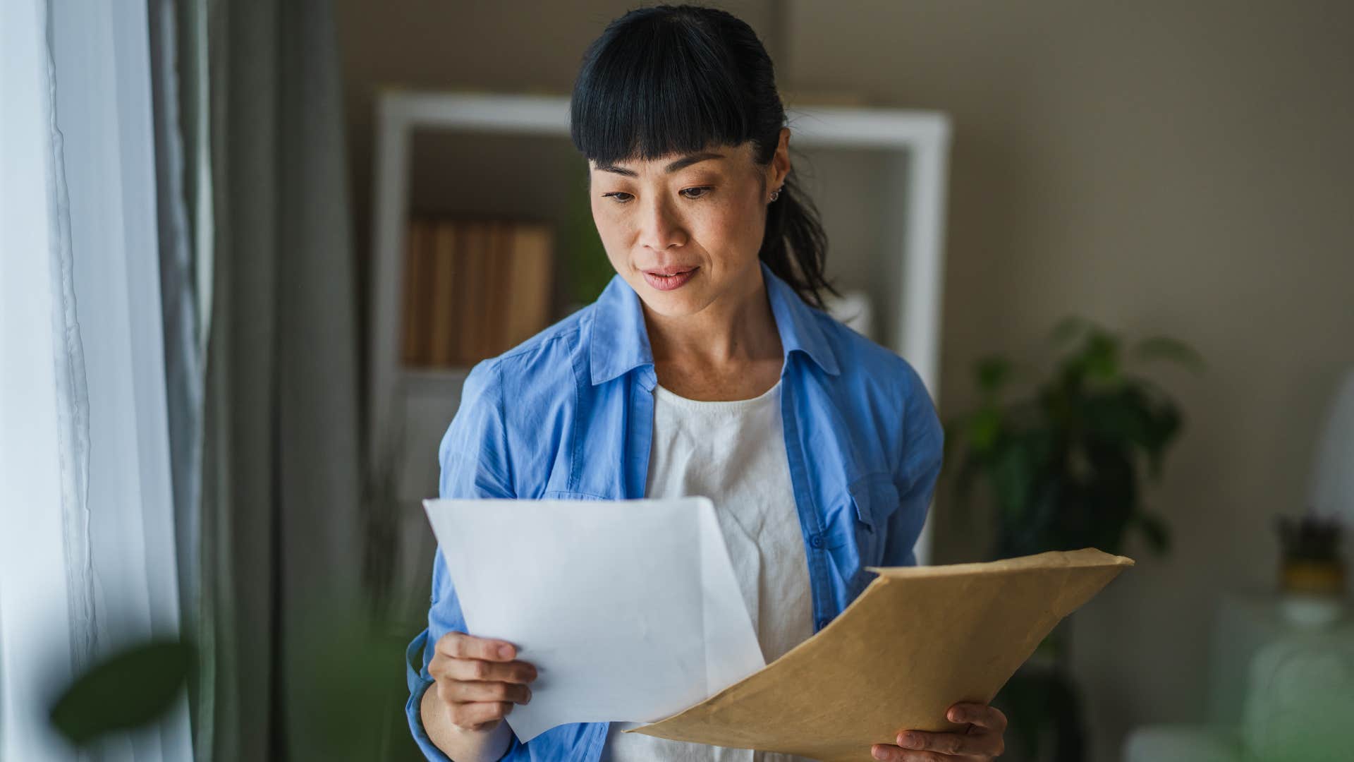 woman looking at important mail 