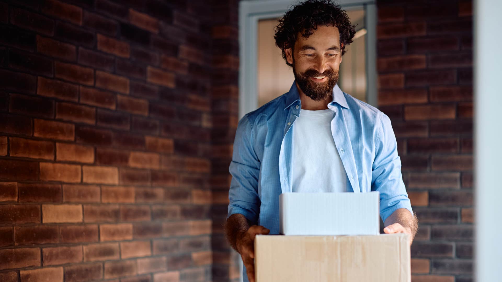 man grabbing packages left on his porch