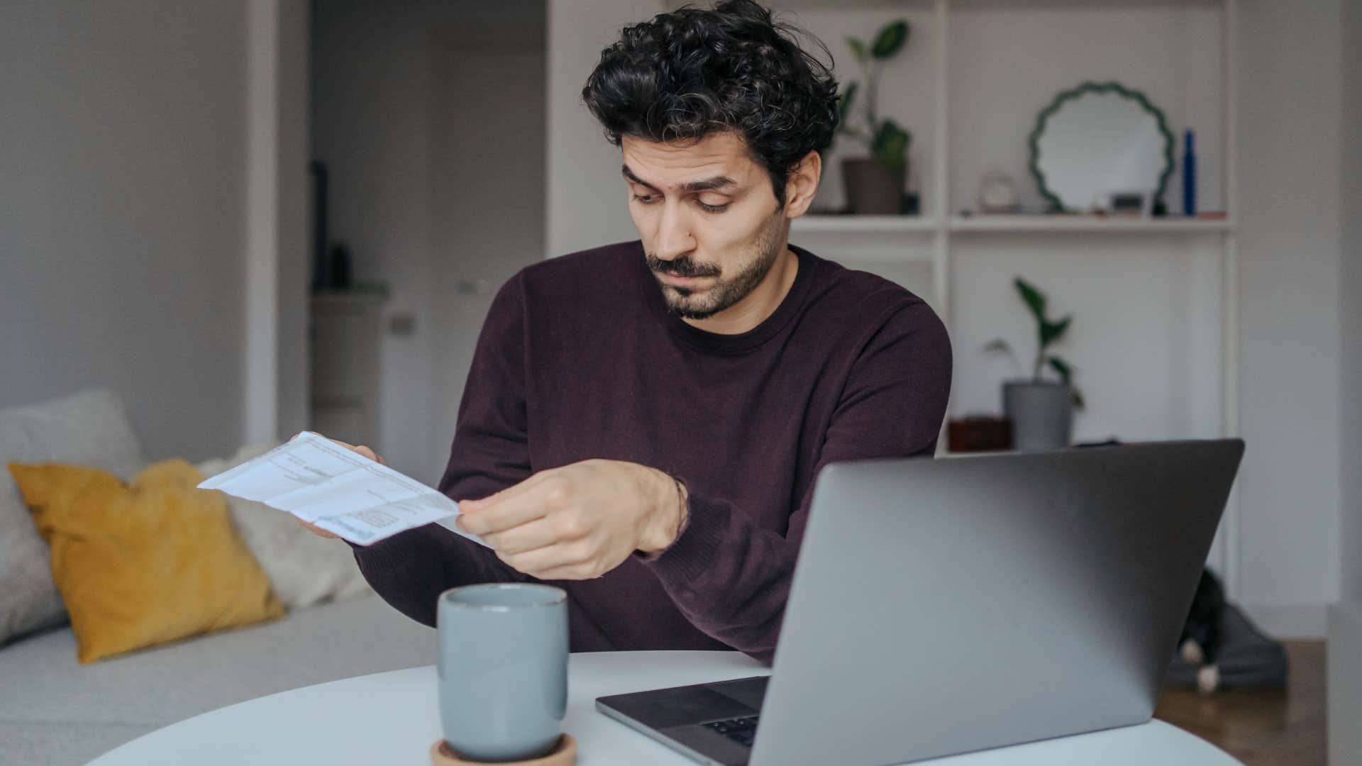 man looking at personal documents at home