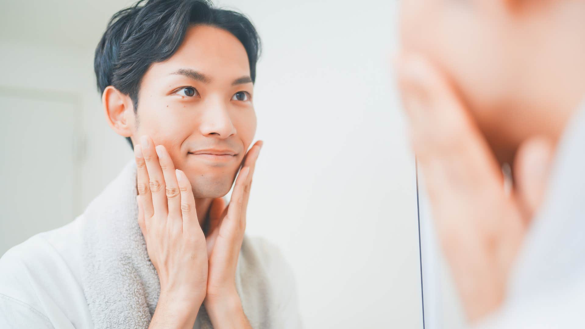man washing his face in the bathroom