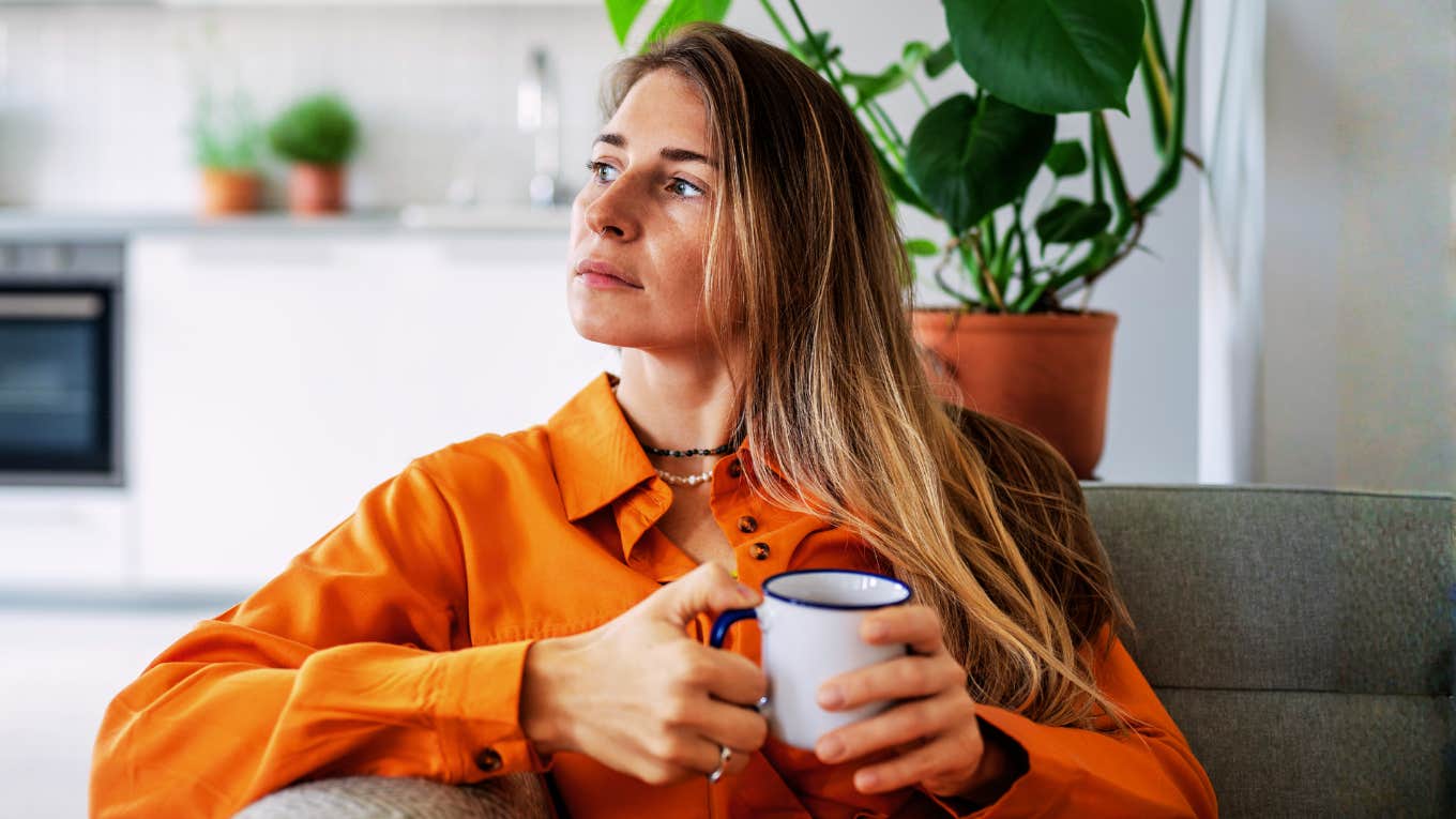 Thoughtful midlife woman looking out a window showing the quiet wishes wives have most at midlife according to a clinical psychologist