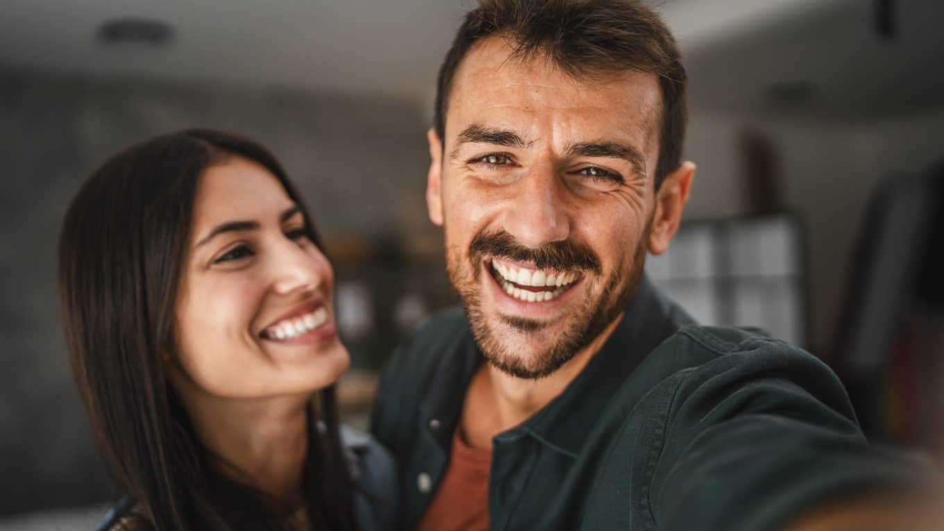happy couple smiling taking a selfie