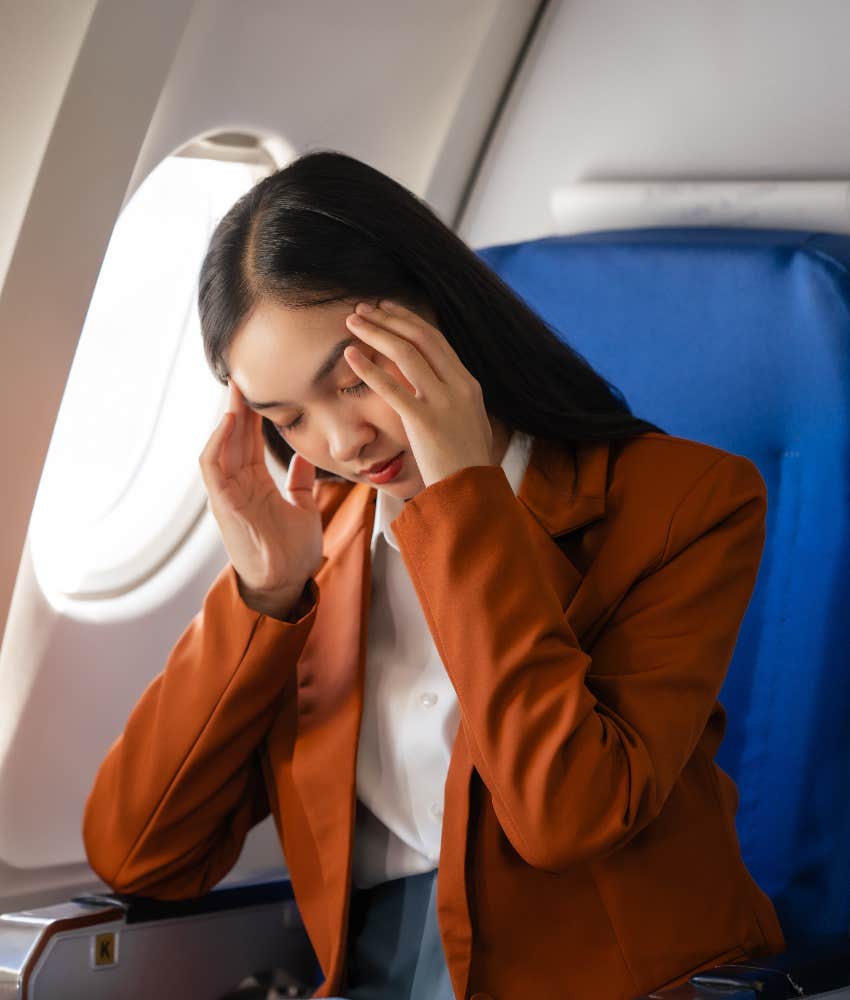 woman uncomfortable in plane seat