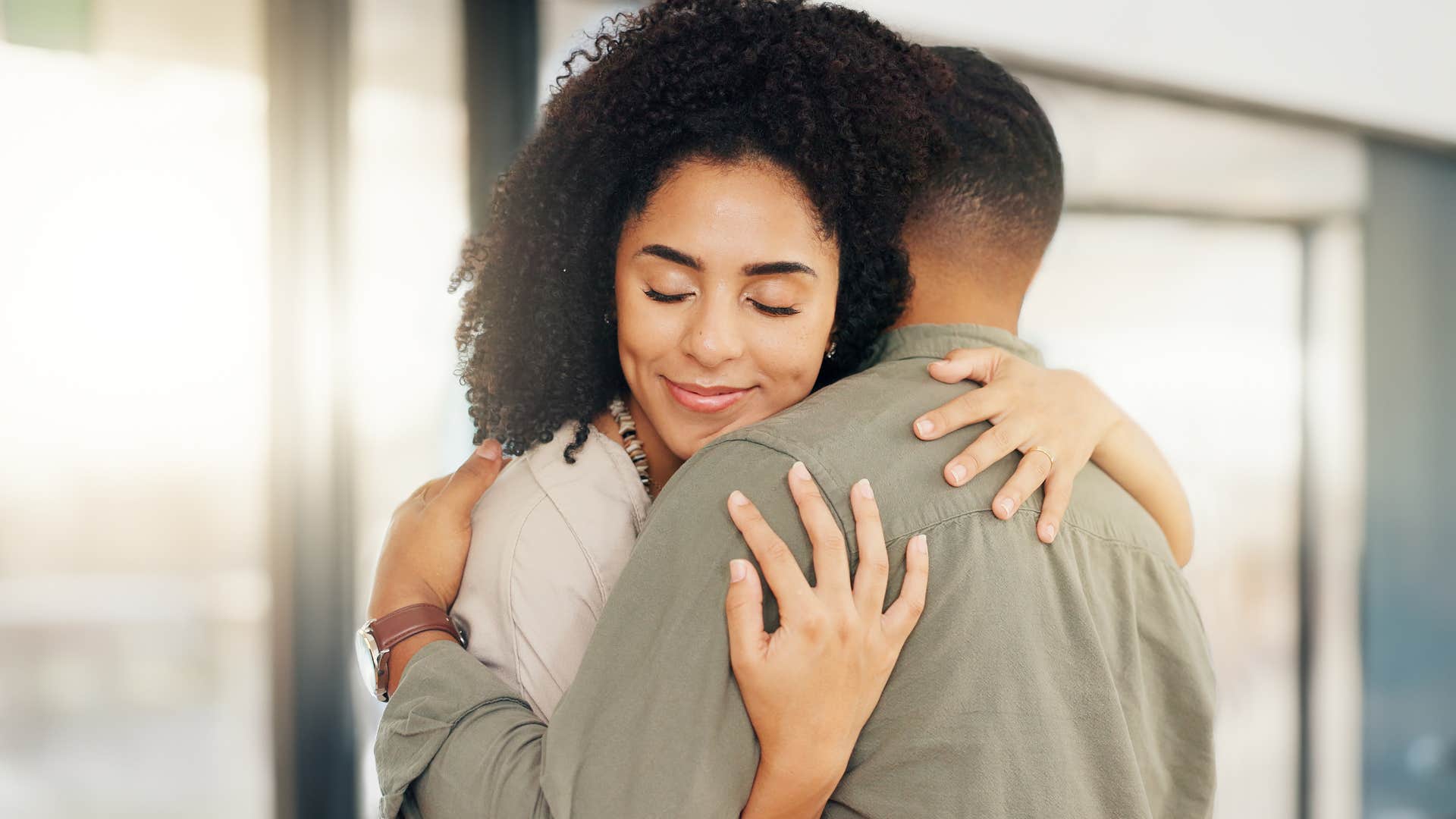 man hugging a woman who holds him accountable