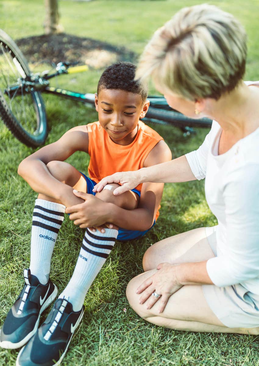 little boy who hurt his knee with a bandaid